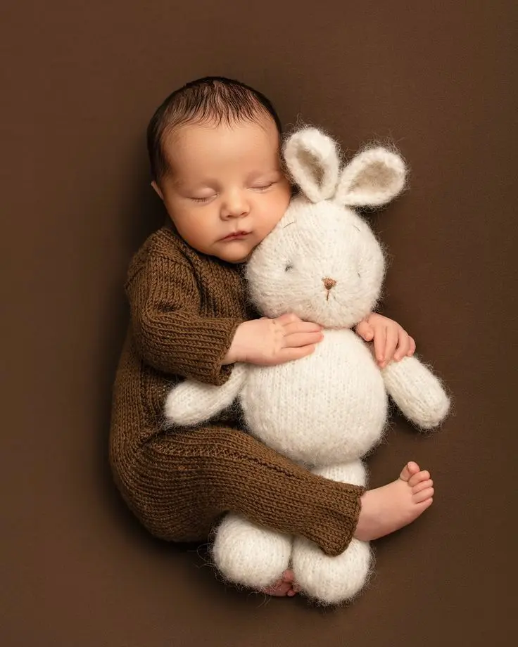 A newborn baby, solid brown with bunny toy Nano Banana prompt example